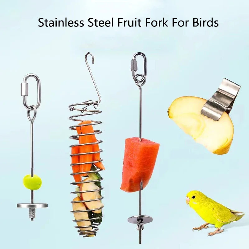 Stainless steel fruit fork bird feeder with various fruits and a yellow bird