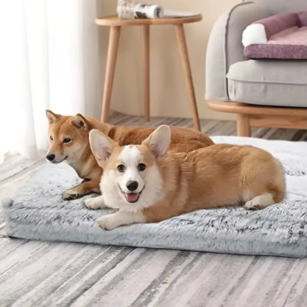 A golden-colored dog is lying on a gray plush pet bed indoors.