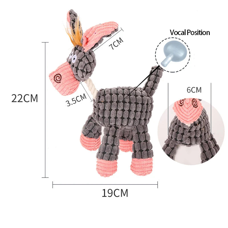 A gray knitted plush toy shaped like a rabbit with pink ears and a silver squeaker, shown from the side.