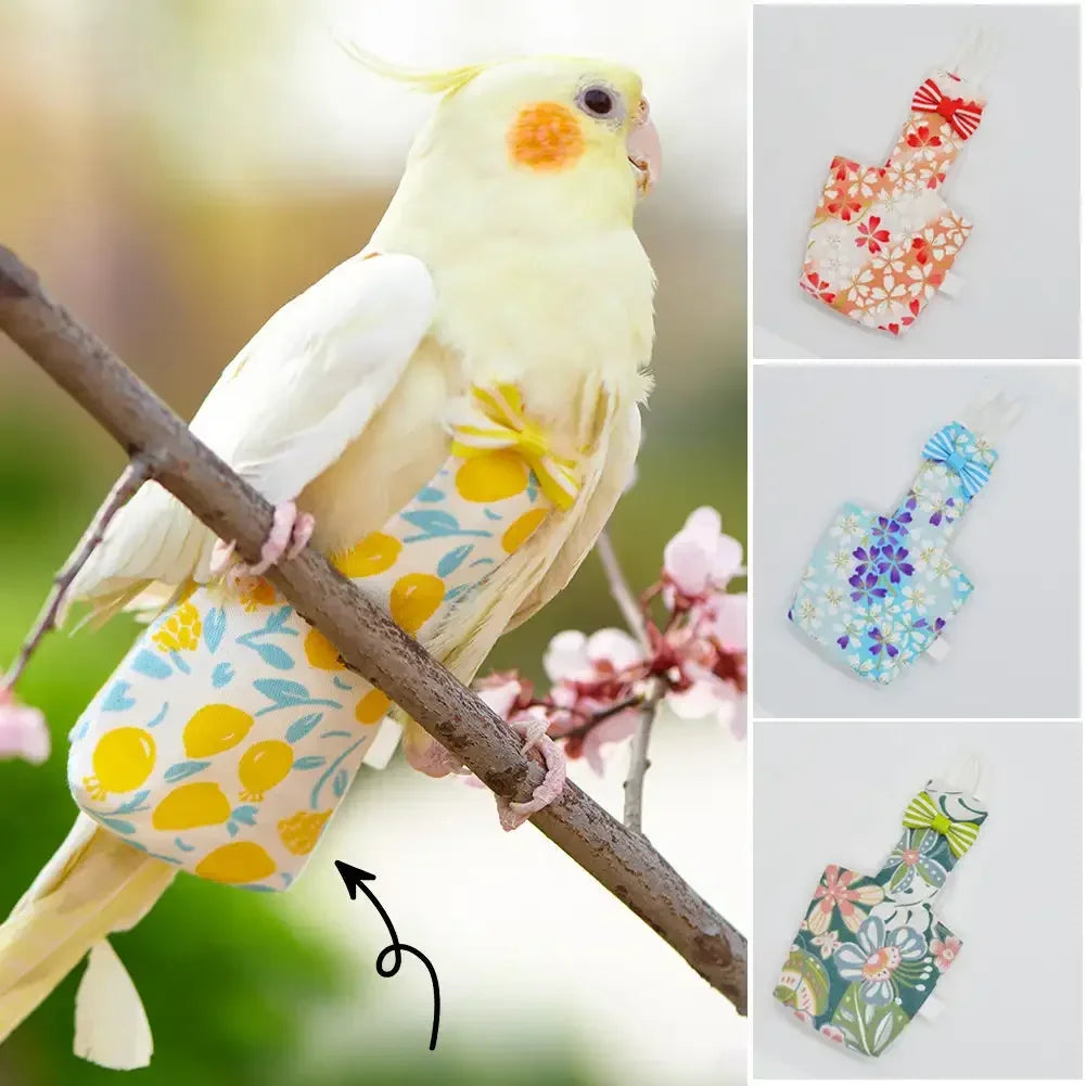 A yellow and white parrot wearing a floral patterned diaper flight suit with a bow tie perched on a branch.