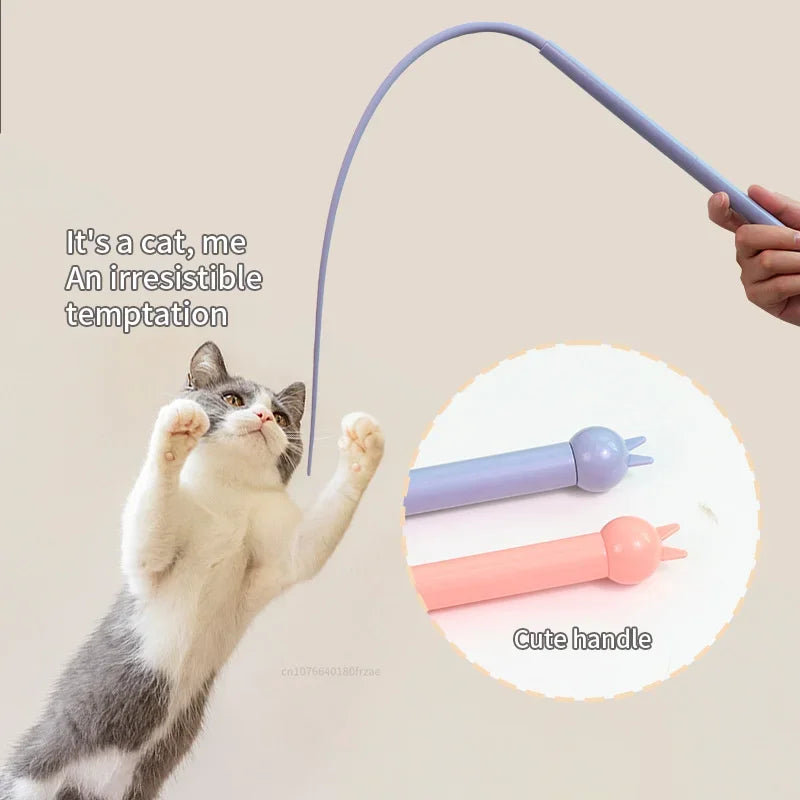 A cat is playing with a purple silicone toy that has a cute handle.
