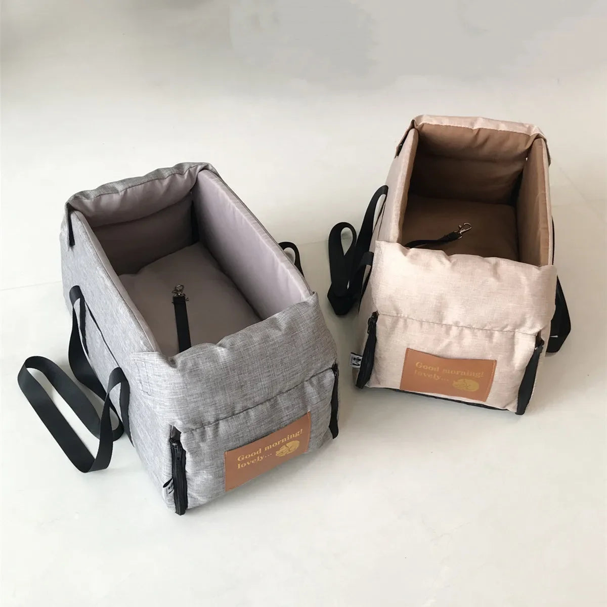 A light gray portable pet car seat carrier for small dogs and cats shown in open view.