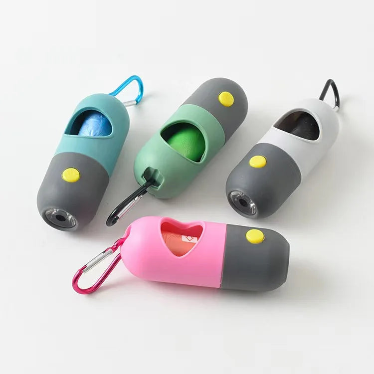 A collection of capsule dog waste bag dispensers in various colors, including teal, green, and pink, with attached loops.