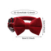 A red plush velvet pet collar featuring a bow and a bell.