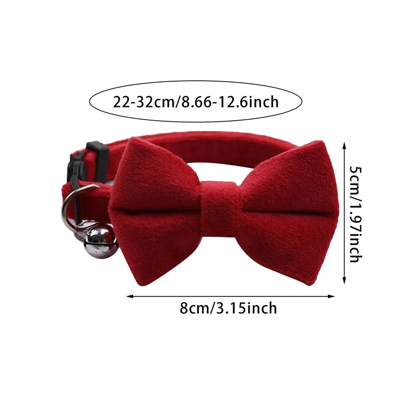 A red plush velvet pet collar featuring a bow and a bell.