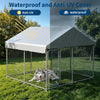 A silver metal dog kennel with a waterproof cover and feeding door is shown outdoors on green grass.