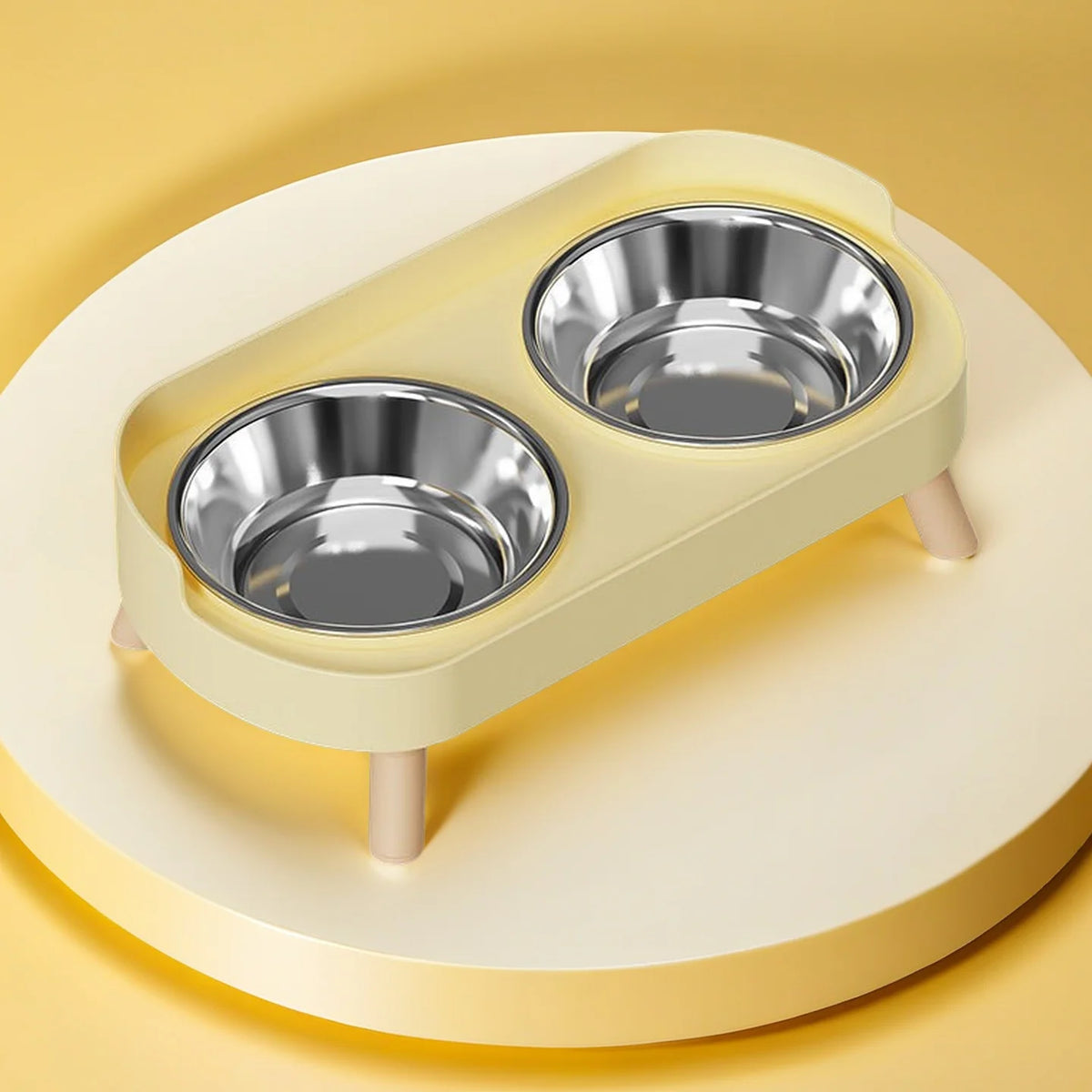 A light yellow elevated pet feeder with two stainless steel bowls is shown on a round platform.
