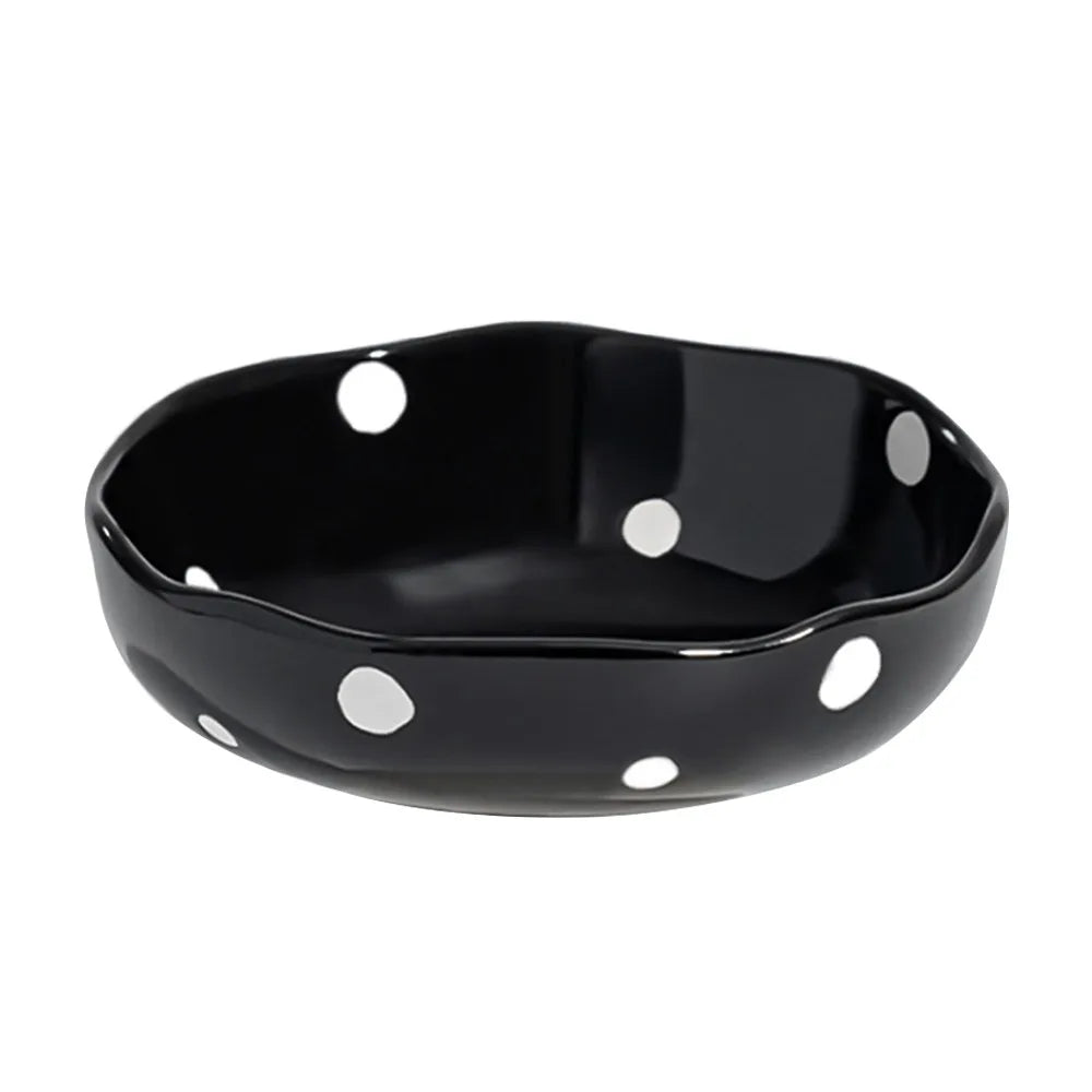 Black ceramic pet bowl with white polka dots and a raised neck for protection
