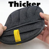 A hand holds a black reusable pet grooming glove with a yellow accent on the palm side.