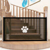 A black pet safety mesh gate is installed on a wooden staircase railing.