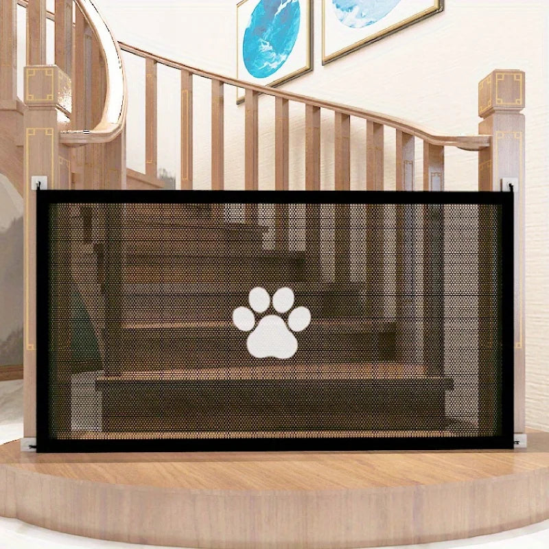 A black pet safety mesh gate is installed on a wooden staircase railing.