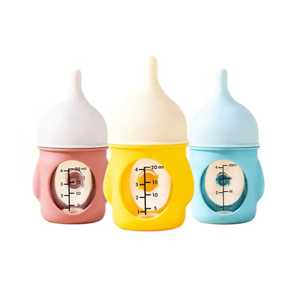 Three silicone pet nursing bottles in pink, cream, and light blue with anti-choking valves.
