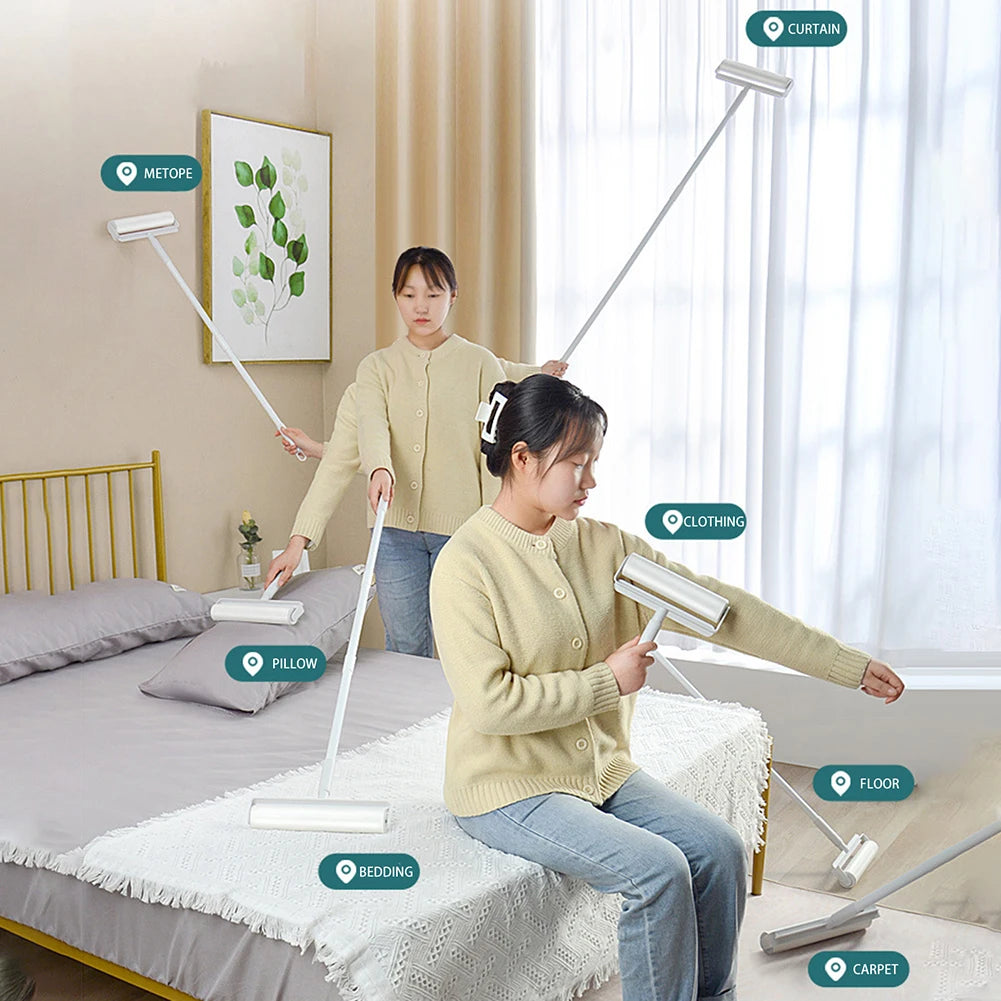A woman is using a long extendable lint roller on various surfaces like curtains, clothing, floor, and carpet in a bedroom se