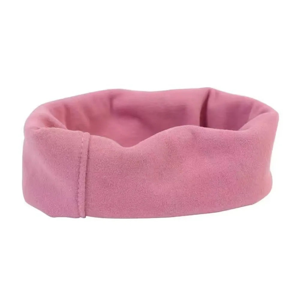 A pink, soft fabric dog ear muff designed for comfort and noise reduction.