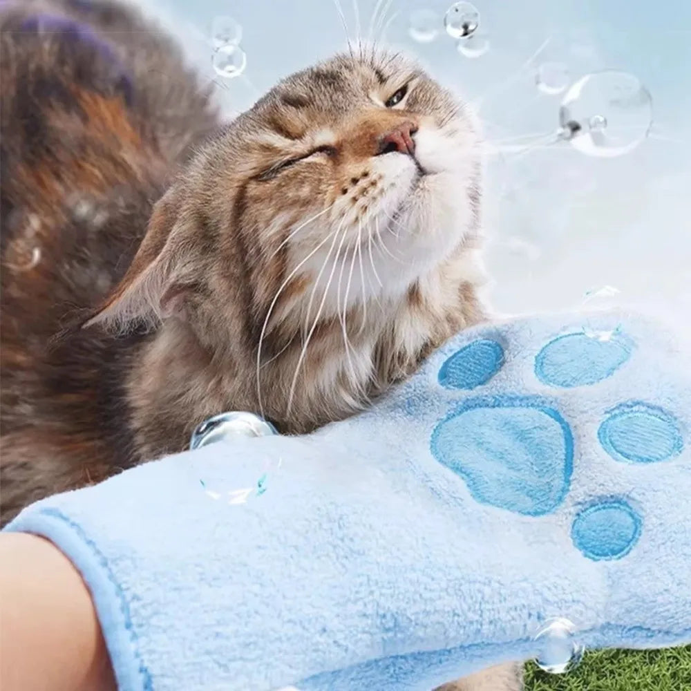 A fluffy cat is resting its face on a light blue quick-dry pet bathing towel glove with paw prints.