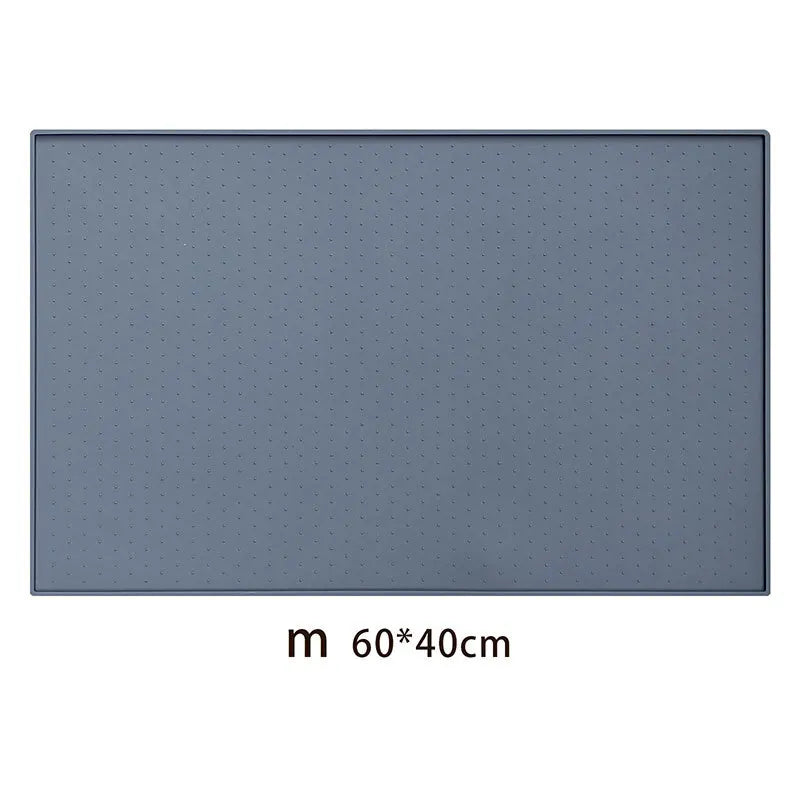 A rectangular gray silicone pet feeding mat with a non-slip surface and a perforated pattern.