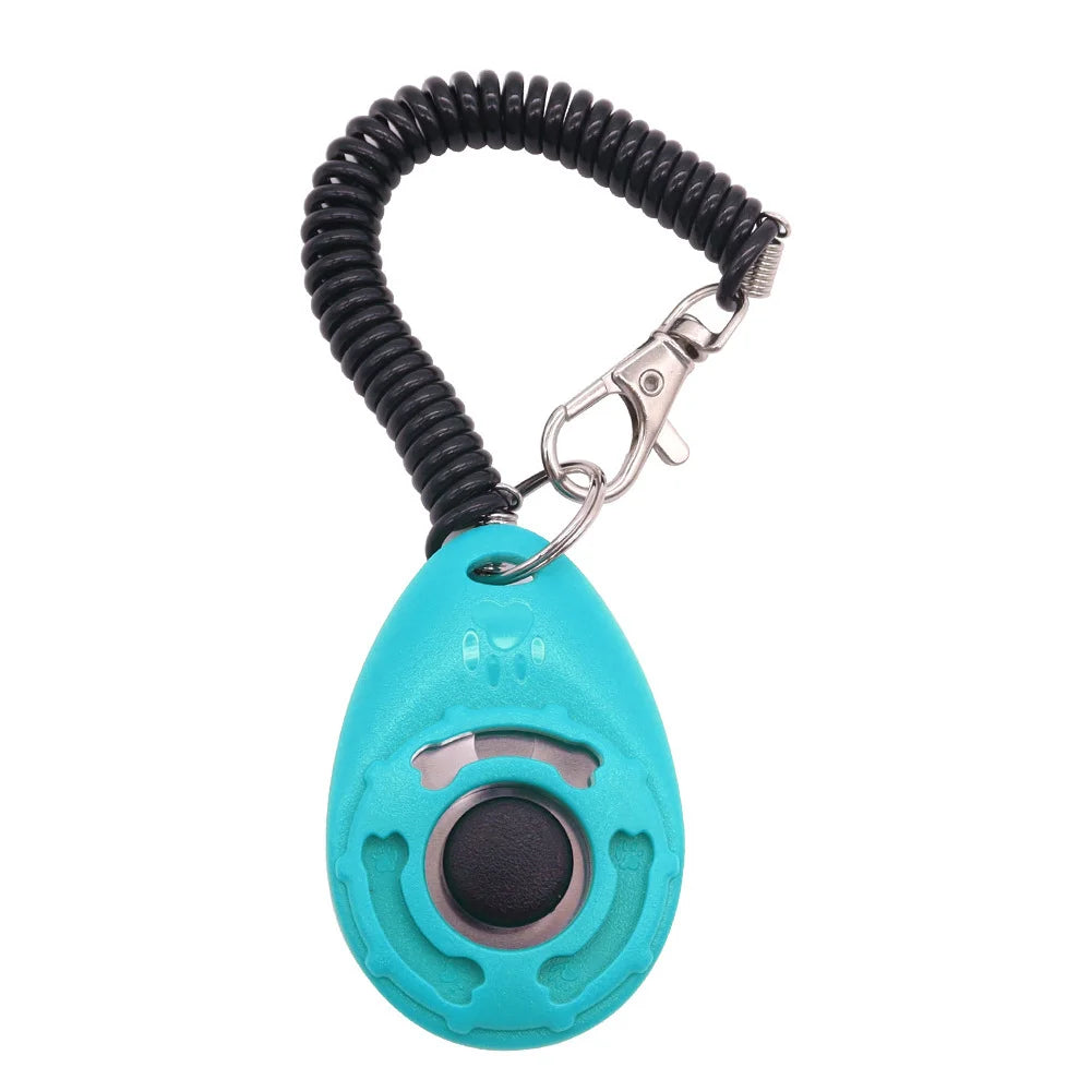 A teal pet training clicker device with a black wrist strap and metal clip.