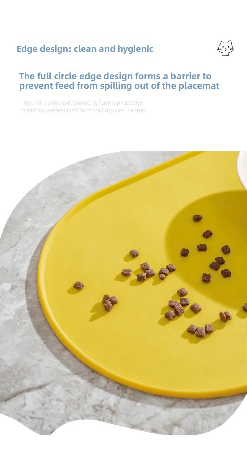 A yellow feeding mat with a full circle edge design, showing scattered dry pet food on the surface.