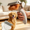 A person is using a white pet grooming brush with an orange-colored pet's fur to detangle the animal's coat.