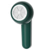 A dark green portable electric lint and fabric shaver with a perforated metal head.