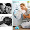 A woman is using reusable lint filter balls inside a washing machine drum to clean laundry.