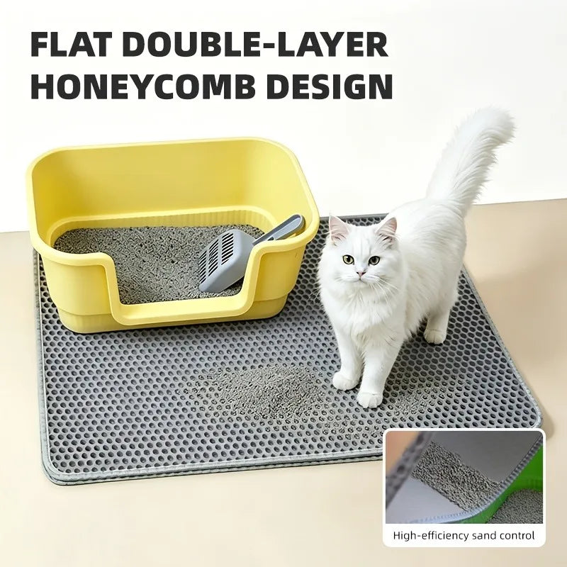 A yellow flat double-layer honeycomb cat litter box and mat with a white cat standing on it.