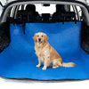 A golden retriever sits on a blue waterproof car trunk mat with a pet barrier inside a vehicle.