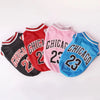A set of three stylish pet dog basketball vests in red, pink, and blue with Chicago text and the number 23.