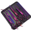 A set of professional stainless steel pet grooming scissors with purple and silver handles and blades, laid out in a black ca