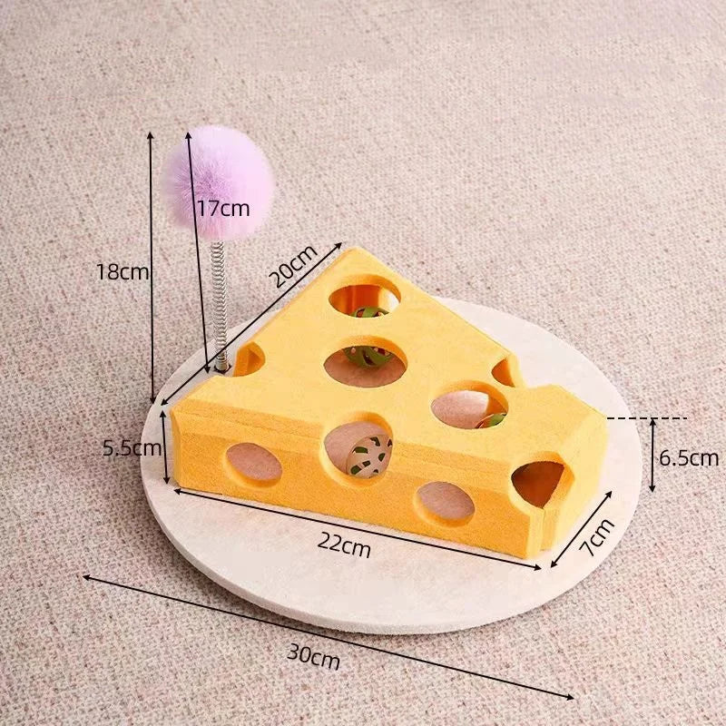 A yellow felt maze puzzle toy shaped like a block with holes, next to a purple pom-pom and measuring tape.