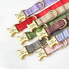 A collection of personalized bowtie dog collars featuring various colors and custom engraved nameplates.