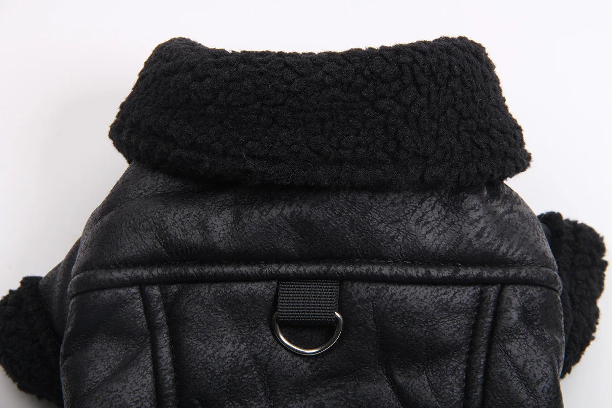 Black winter faux leather dog coat with a thick black fleece lining and a silver buckle detail.