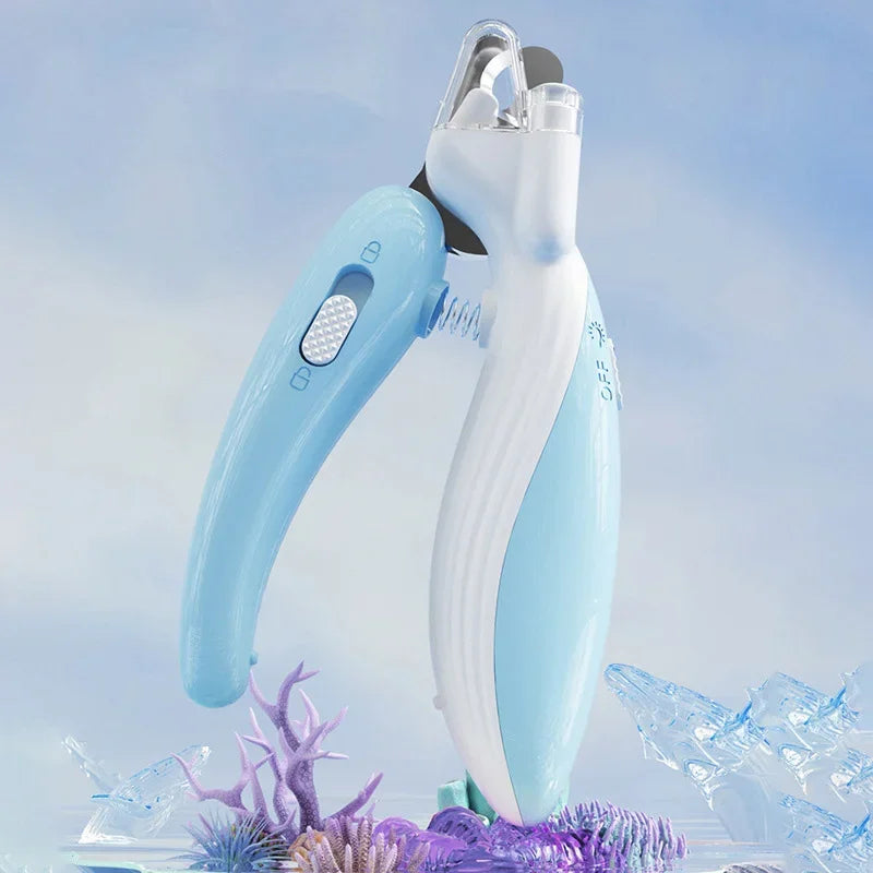 A light blue pet nail clipper with an LED light is shown against a blurred background of ice and purple foliage.
