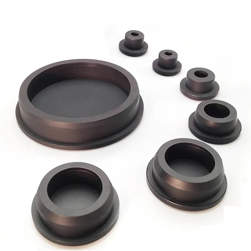 A set of dark silicone rubber hole plugs and seals for various applications.