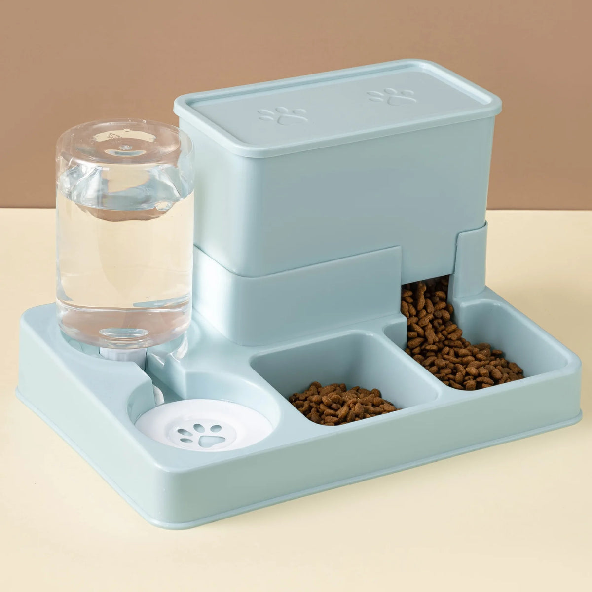 A light blue automatic cat feeder and water fountain device with a separate compartment for dry food.