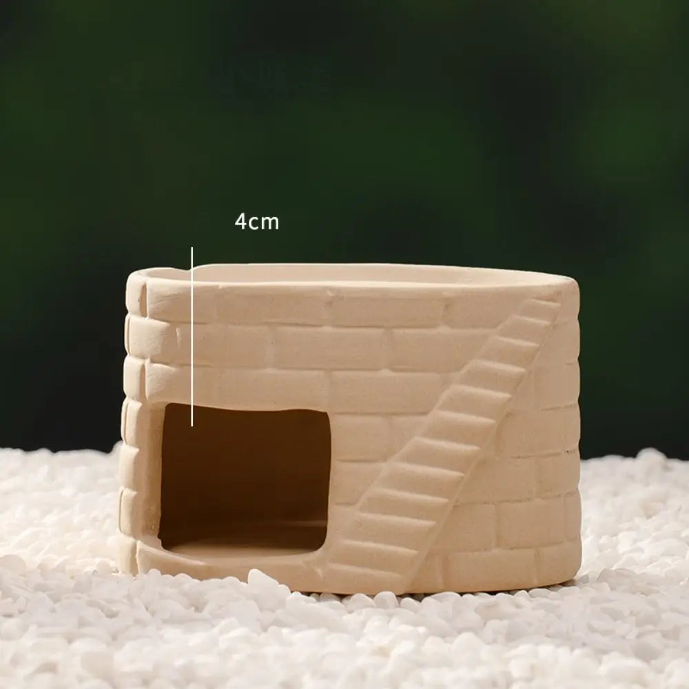 A beige ceramic aquarium shrimp hideaway cave with a rectangular entrance and textured walls.