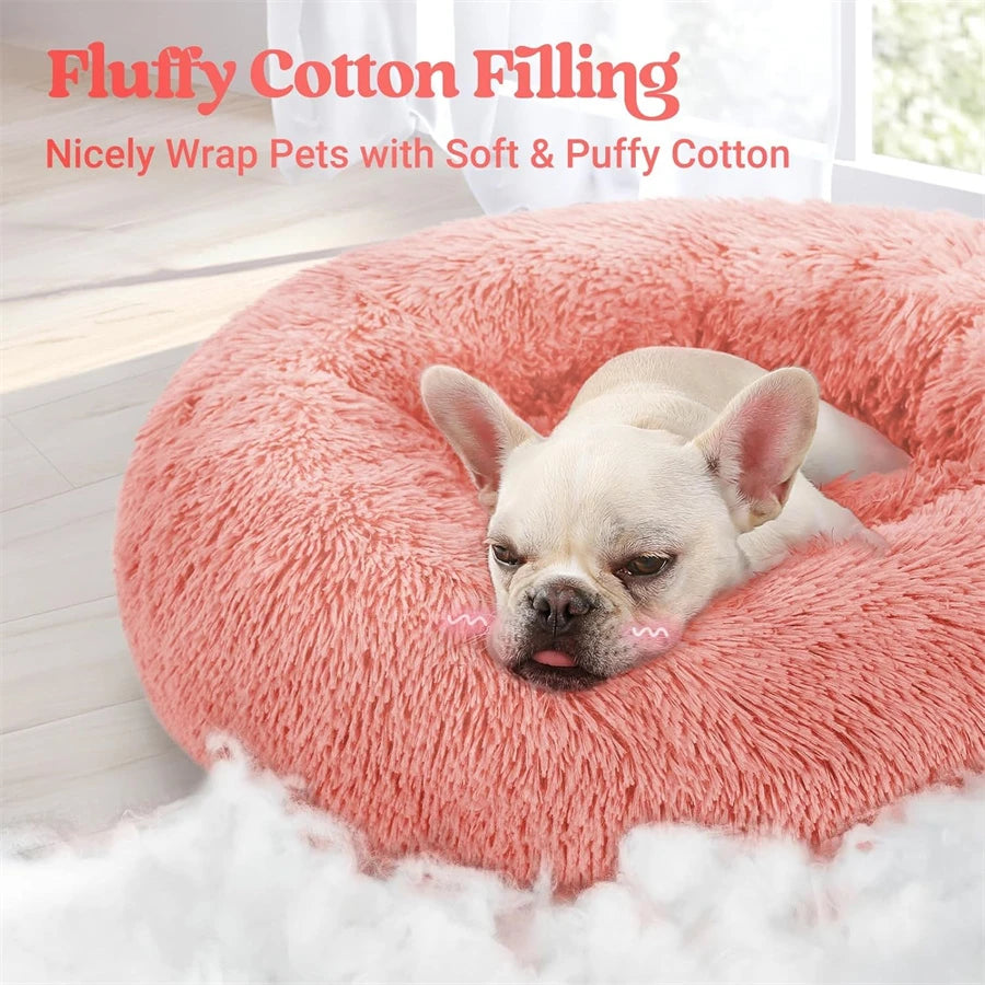 A light pink fluffy cotton filling pet bed with a dog resting on it.