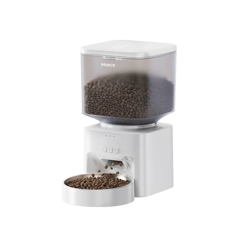 A white smart automatic pet feeder with a clear top, dispensing dark pet food into a removable bowl.