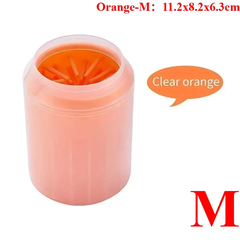 A pink portable paw washer cup with an orange silicone bristled insert.