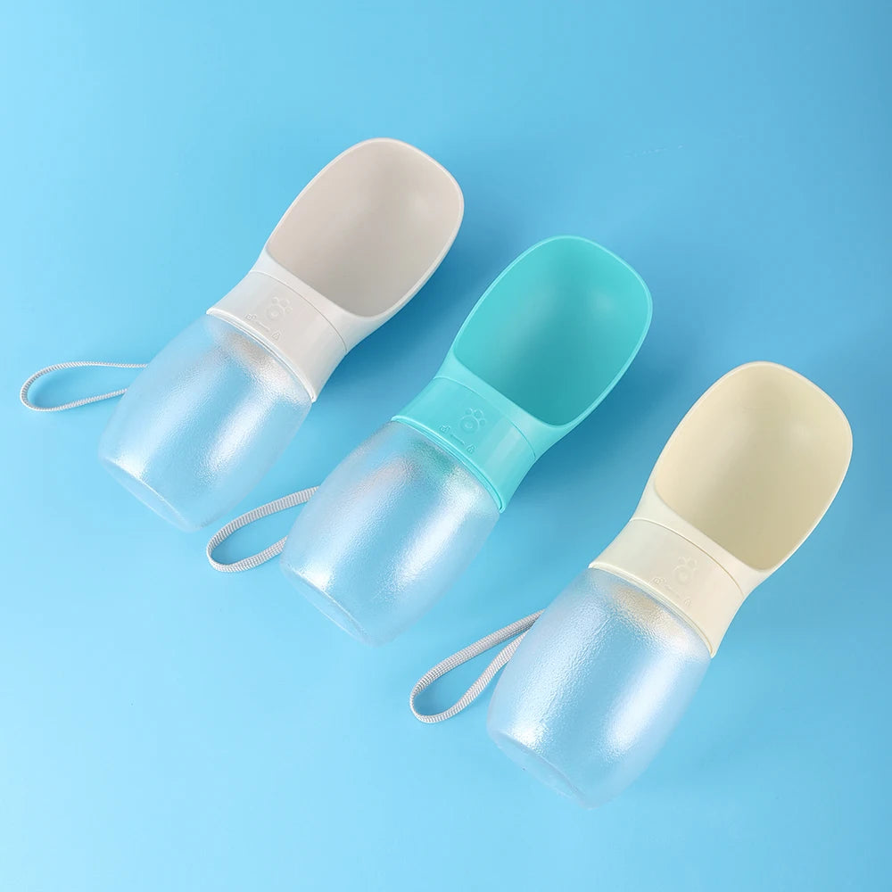 A set of clear and light blue portable pet water bottles with integrated bowls and attached straps.
