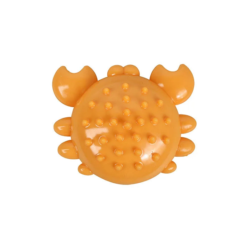 An orange, durable squeaky chew toy shaped like a dog's head with prominent molar teeth.