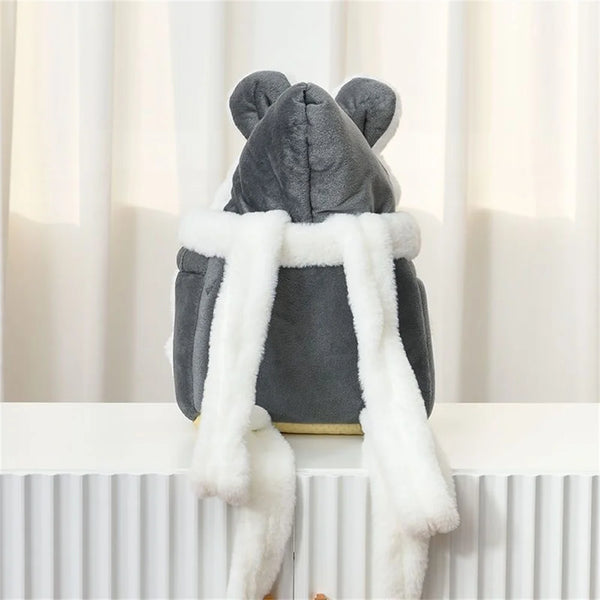 A gray pet carrier backpack with a bear face design and white faux fur trim.