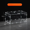A rectangular transparent acrylic reptile terrarium resting on a dark surface.