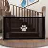 A black portable folding pet safety gate with a mesh panel and a paw print logo is displayed on a wooden surface.