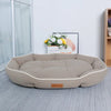 A beige luxurious corduroy pet sofa bed for dogs and cats resting on a light gray rug.
