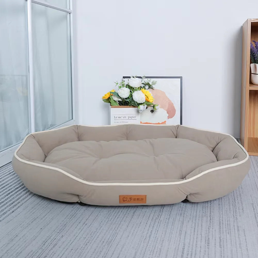 A beige luxurious corduroy pet sofa bed for dogs and cats resting on a light gray rug.