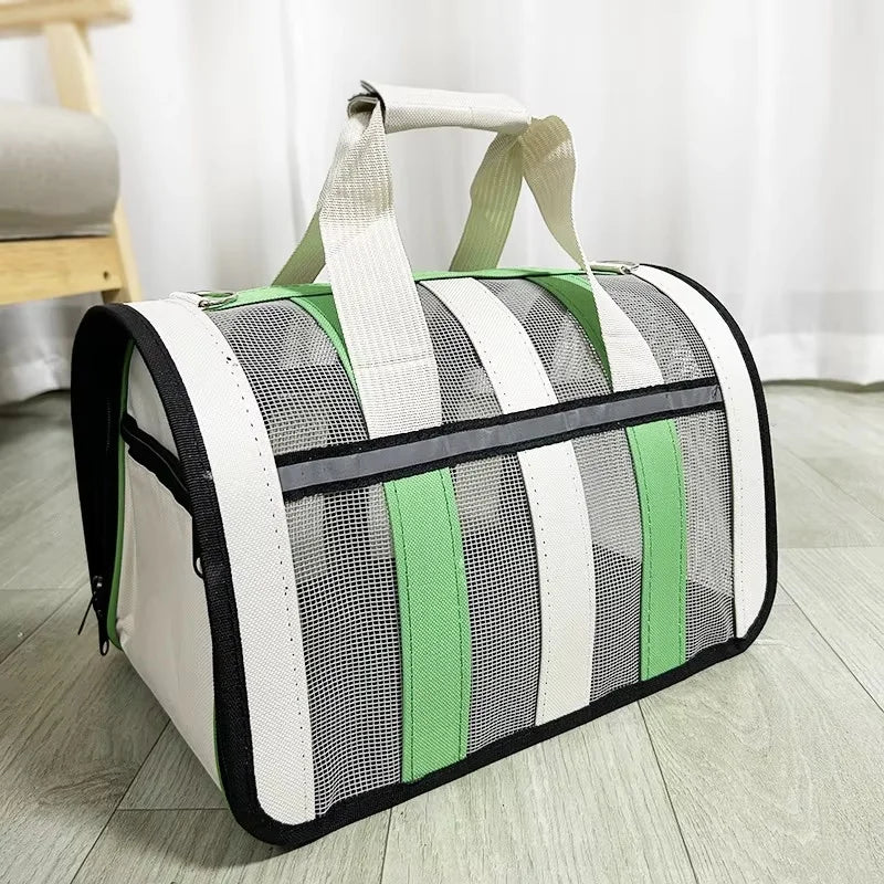 A white and green striped mesh travel carrier bag with light beige straps is shown on a wooden floor.