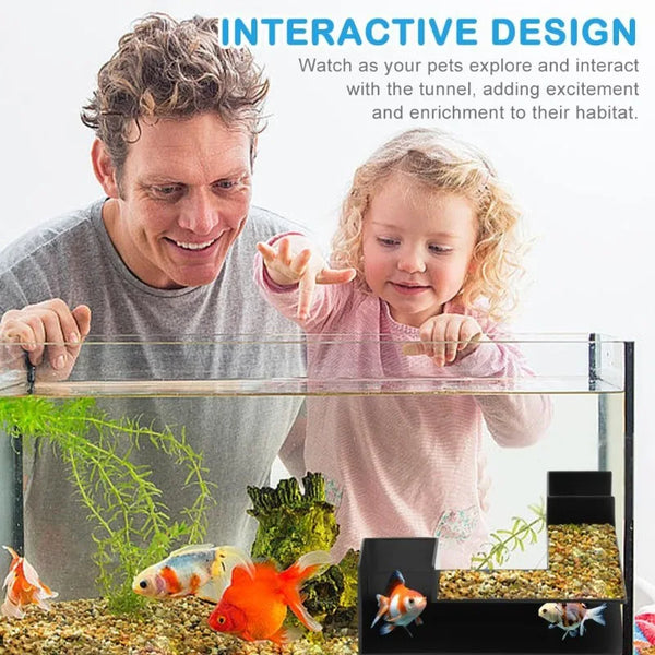 A man and a girl interact with an underground tunnel aquarium featuring various fish and plants.