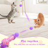 A pink plush ball launcher is shown with purple balls being launched toward a kitten.