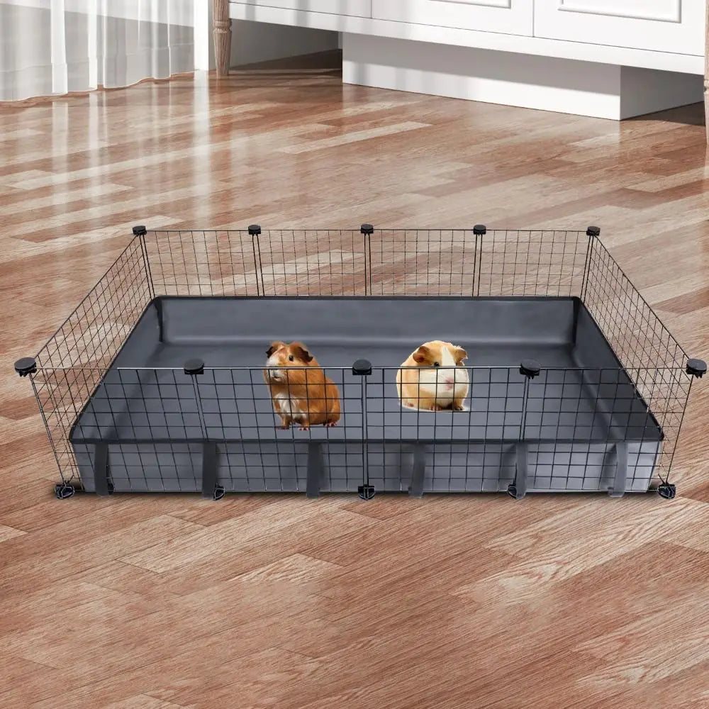 Cage à grillage rectangulaire pour animaux avec un revêtement gris foncé et deux chiens à l'intérieur, posée sur un plancher 